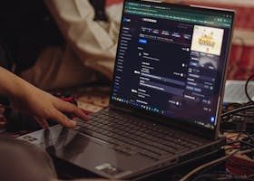 A person setting up a live stream on a laptop, emphasizing technology and connectivity.